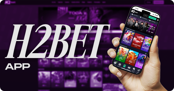 Uma mão segurando um celular com o aplicativo do H2bet aberto nele